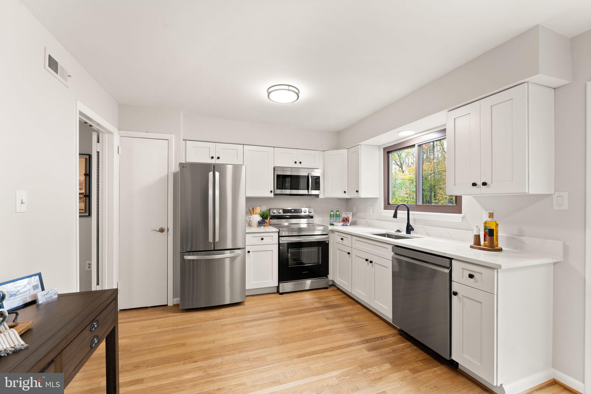 11917 Escalante Court Reston, VA 20191 - Photo 17 of 51 a kitchen with stainless steel appliances a stove refrigerator sink and microwave
