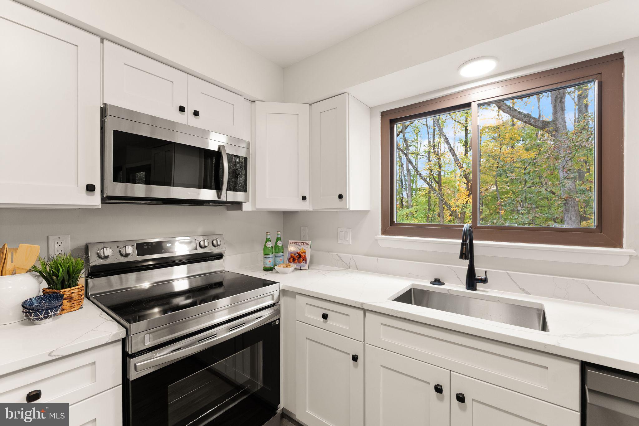 11917 Escalante Court Reston, VA 20191 - Photo 20 of 51 a kitchen with a sink stove top oven and cabinets