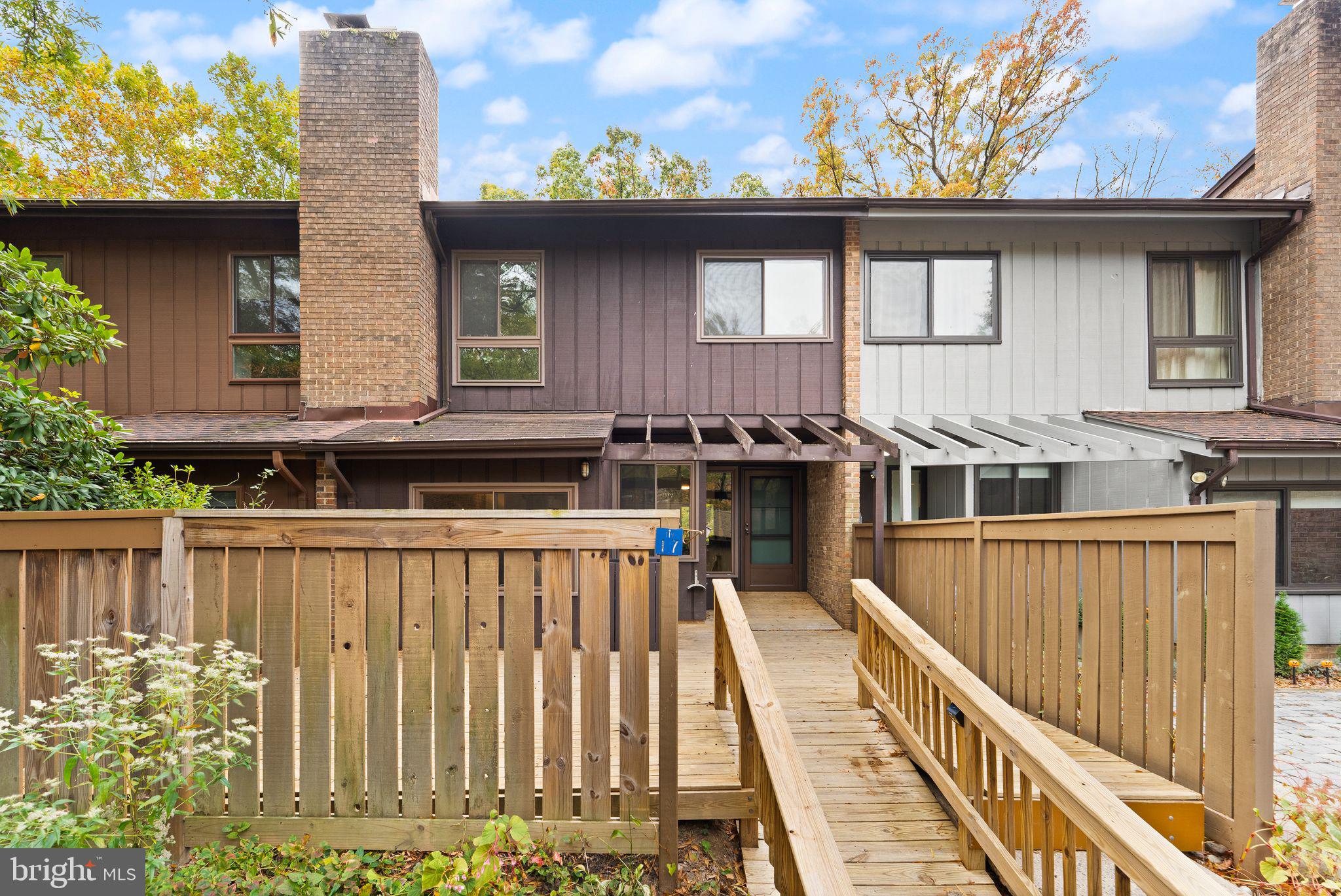 11917 Escalante Court Reston, VA 20191 - Photo 2 of 51 a view of a house with wooden deck and furniture