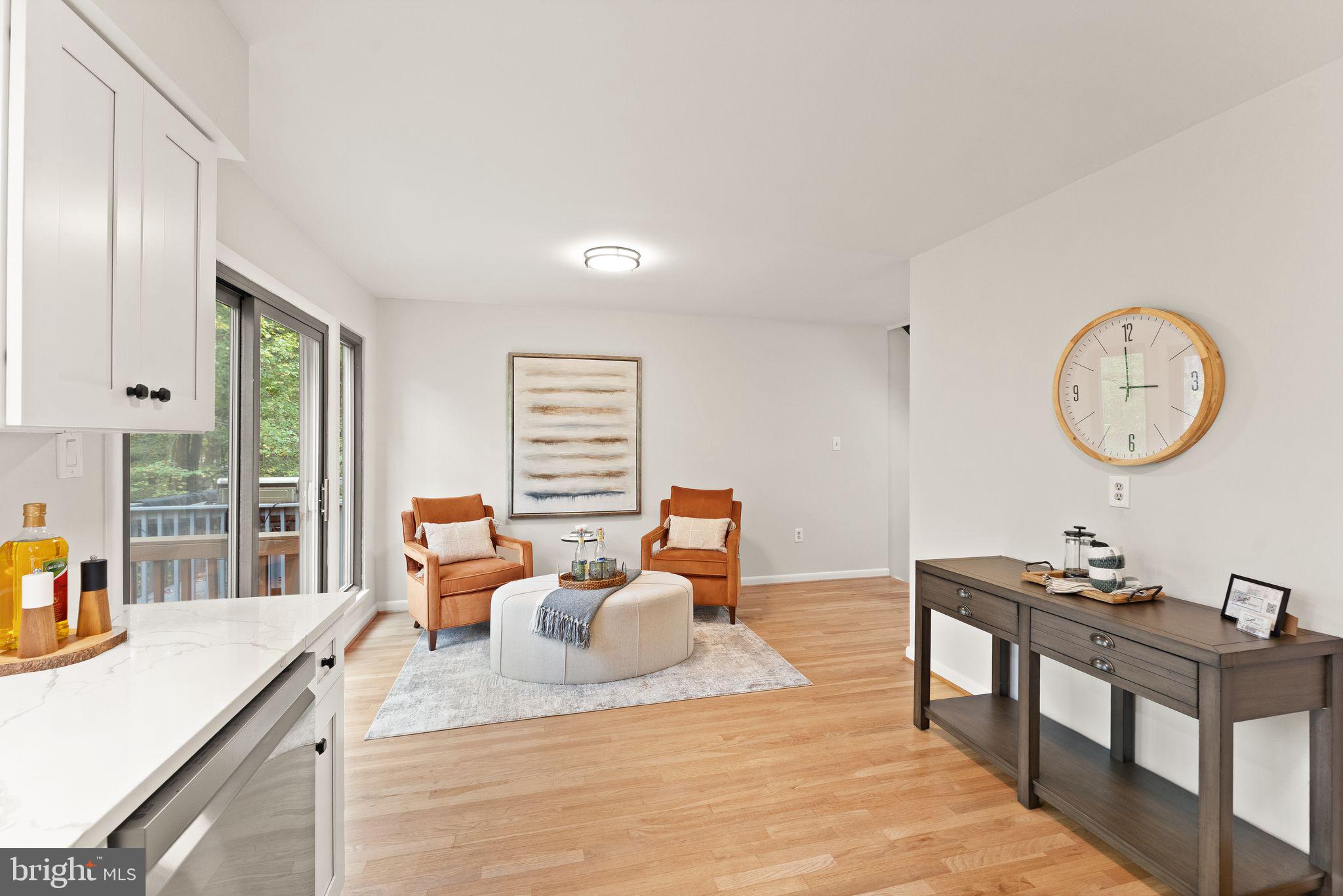 11917 Escalante Court Reston, VA 20191 - Photo 21 of 51 a living room with furniture a large window and a chandelier