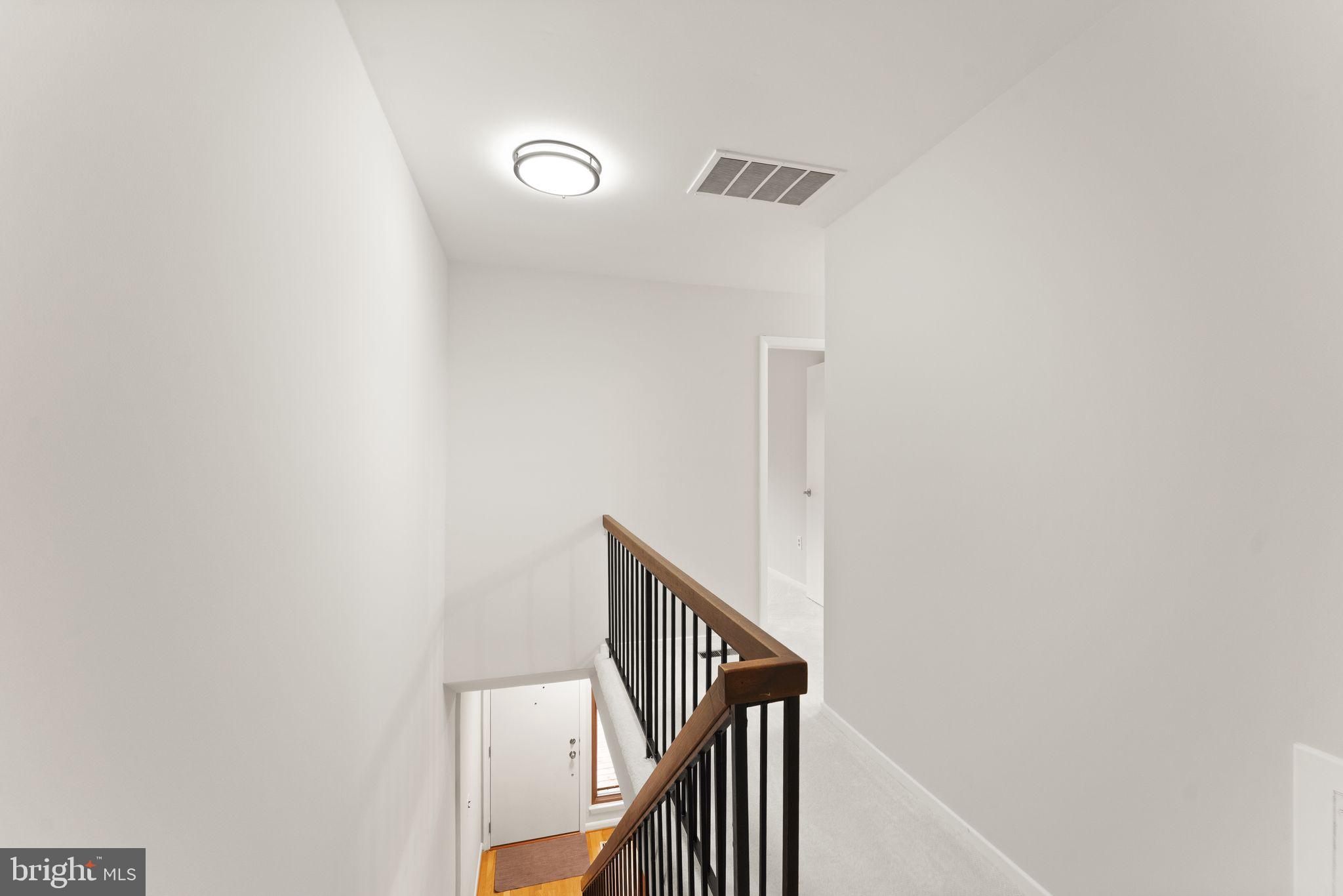 11917 Escalante Court Reston, VA 20191 - Photo 27 of 51 a view of a hallway with staircase