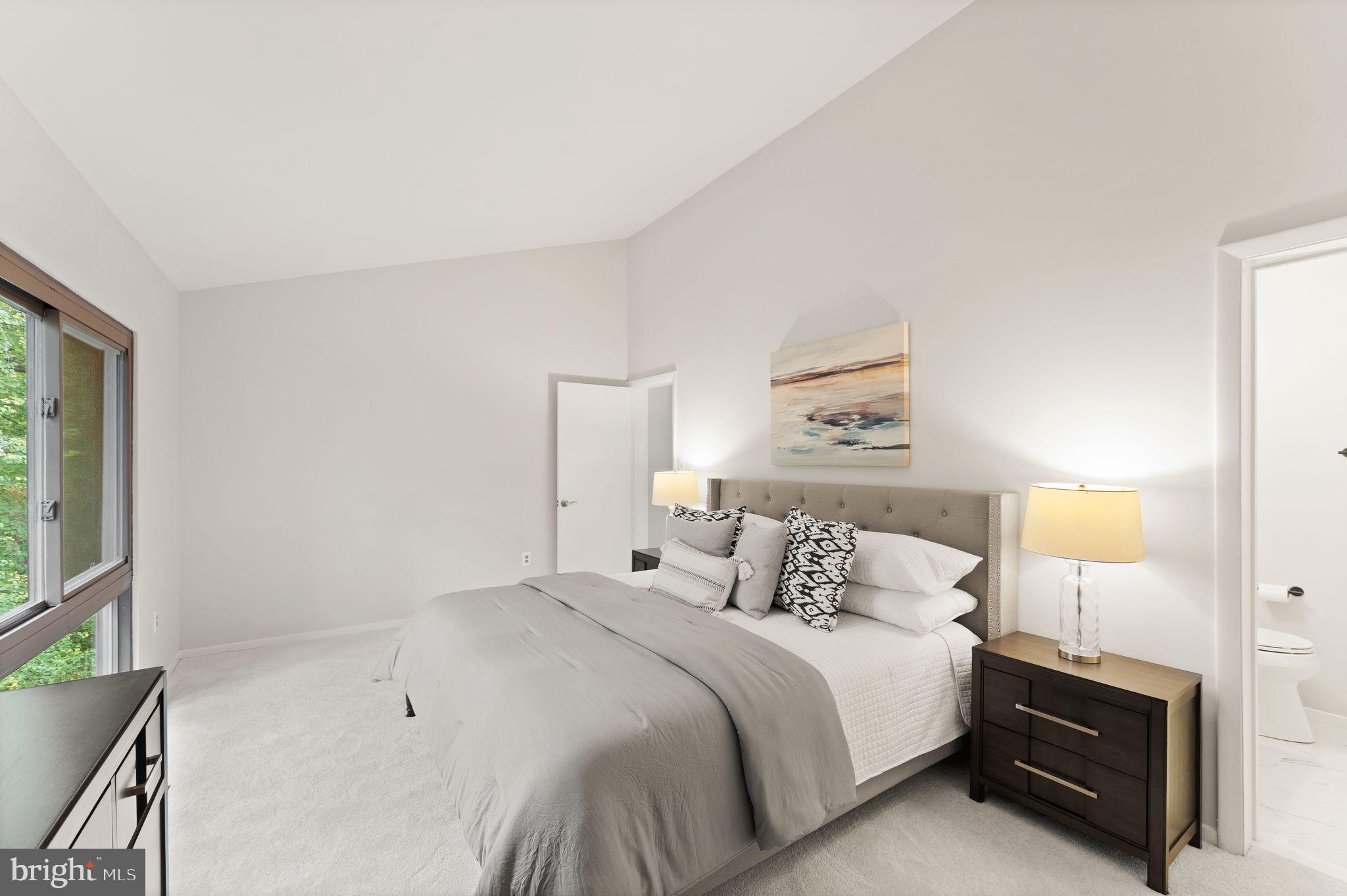 11917 Escalante Court Reston, VA 20191 - Photo 30 of 51 a bedroom with a bed and a night stand