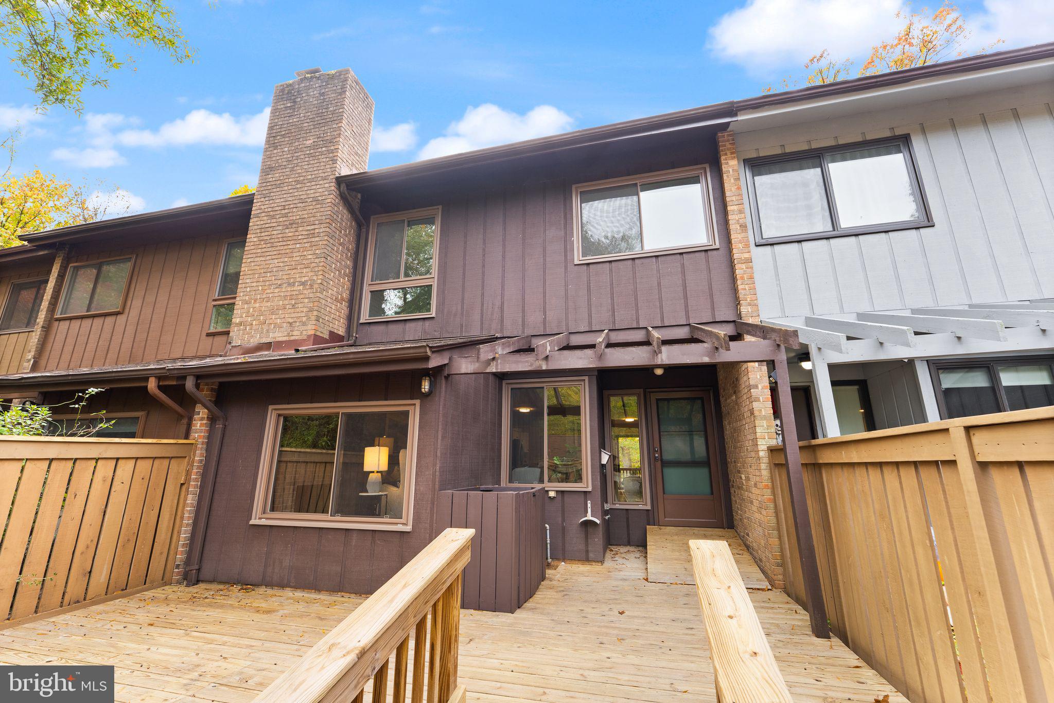 11917 Escalante Court Reston, VA 20191 - Photo 3 of 51 a front view of a house with a barbeque and wooden stairs