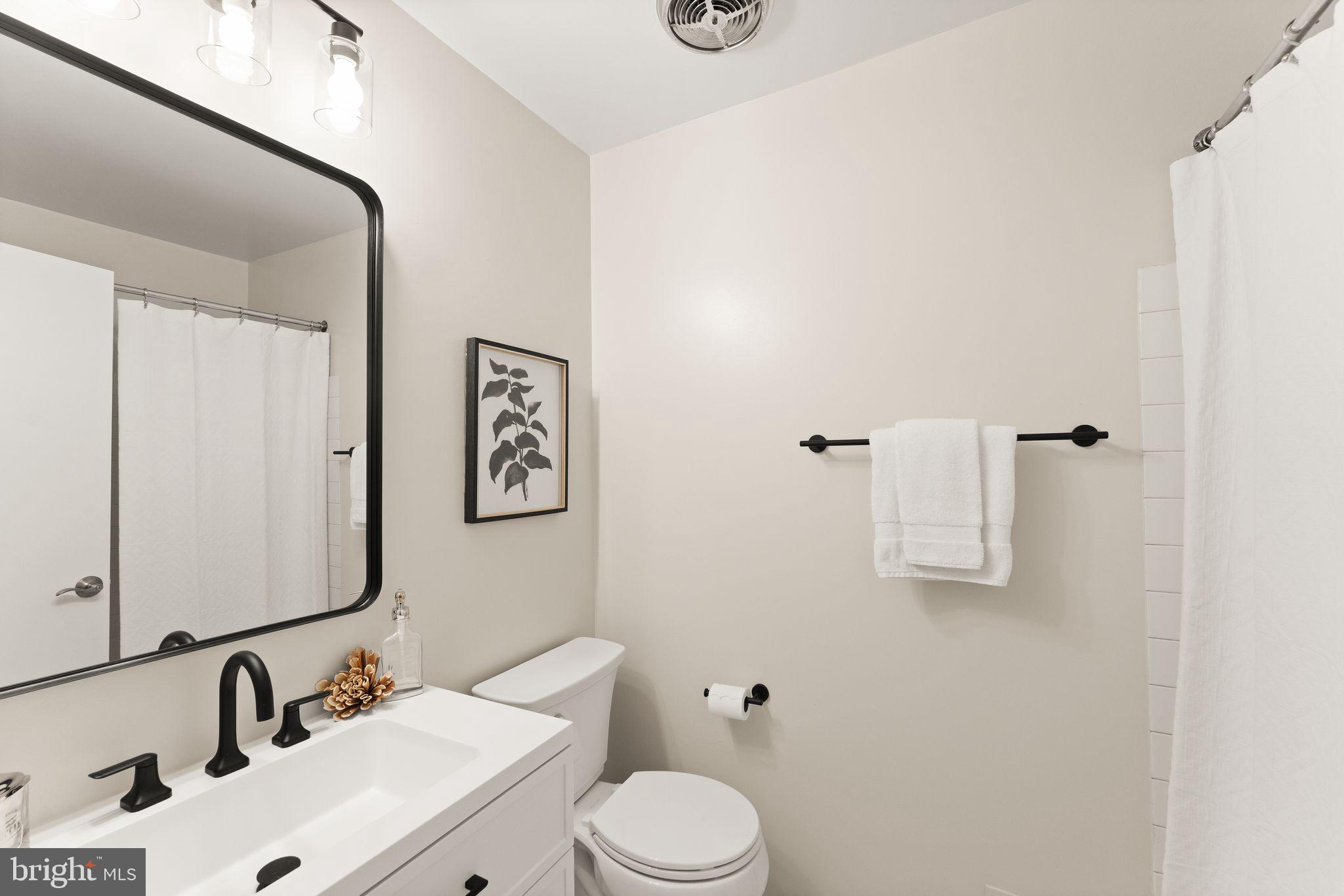 11917 Escalante Court Reston, VA 20191 - Photo 31 of 51 a bathroom with a sink mirror and toilet