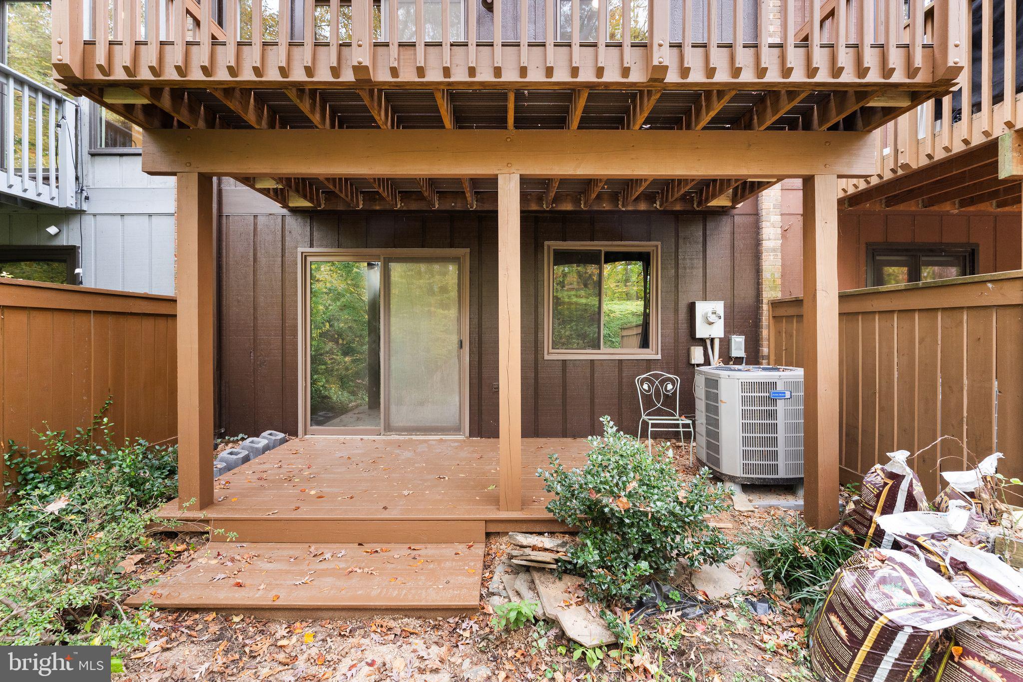 11917 Escalante Court Reston, VA 20191 - Photo 44 of 51 a view of a patio with table and chairs potted plants
