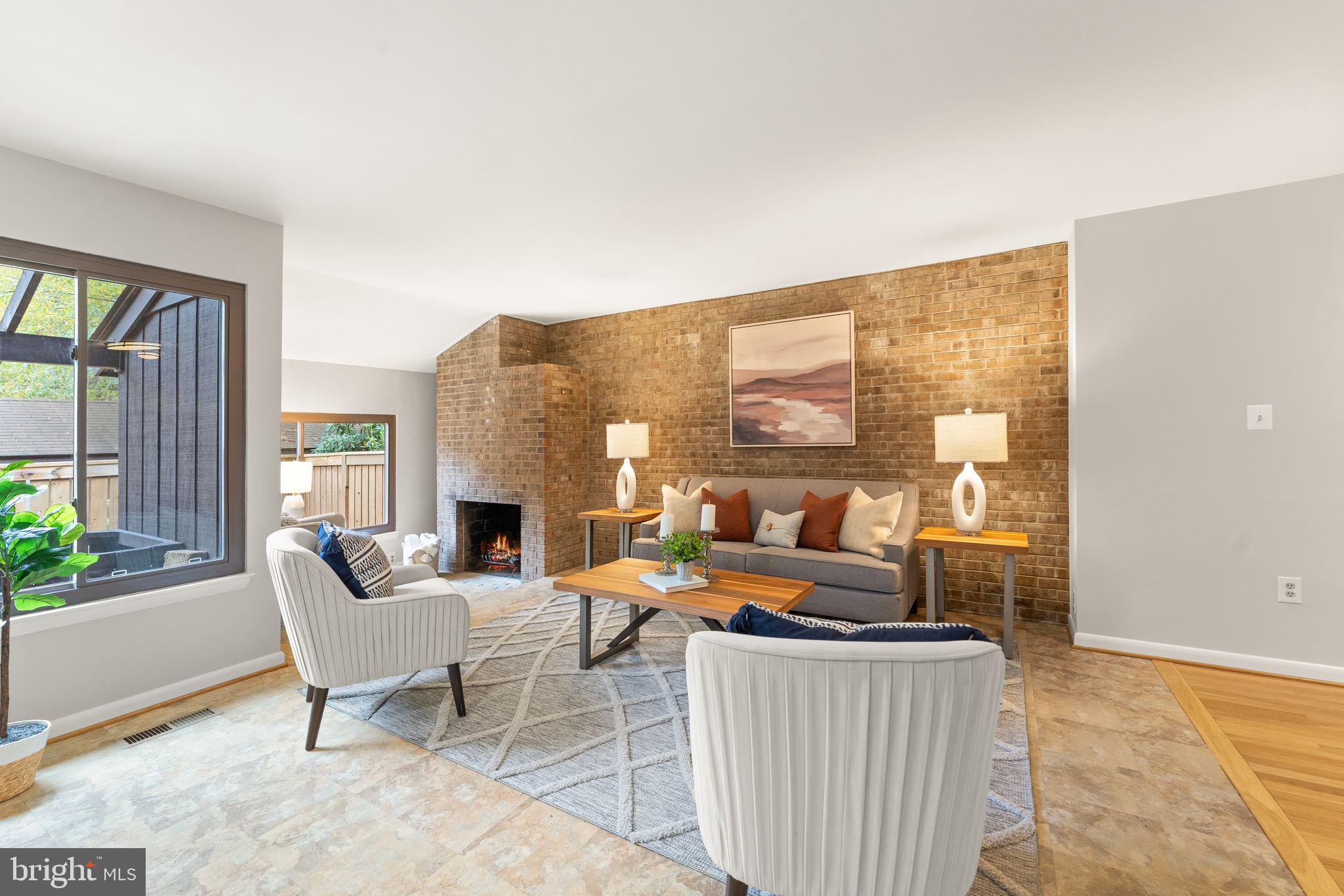 11917 Escalante Court Reston, VA 20191 - Photo 7 of 51 a living room with furniture a fireplace and a floor to ceiling window
