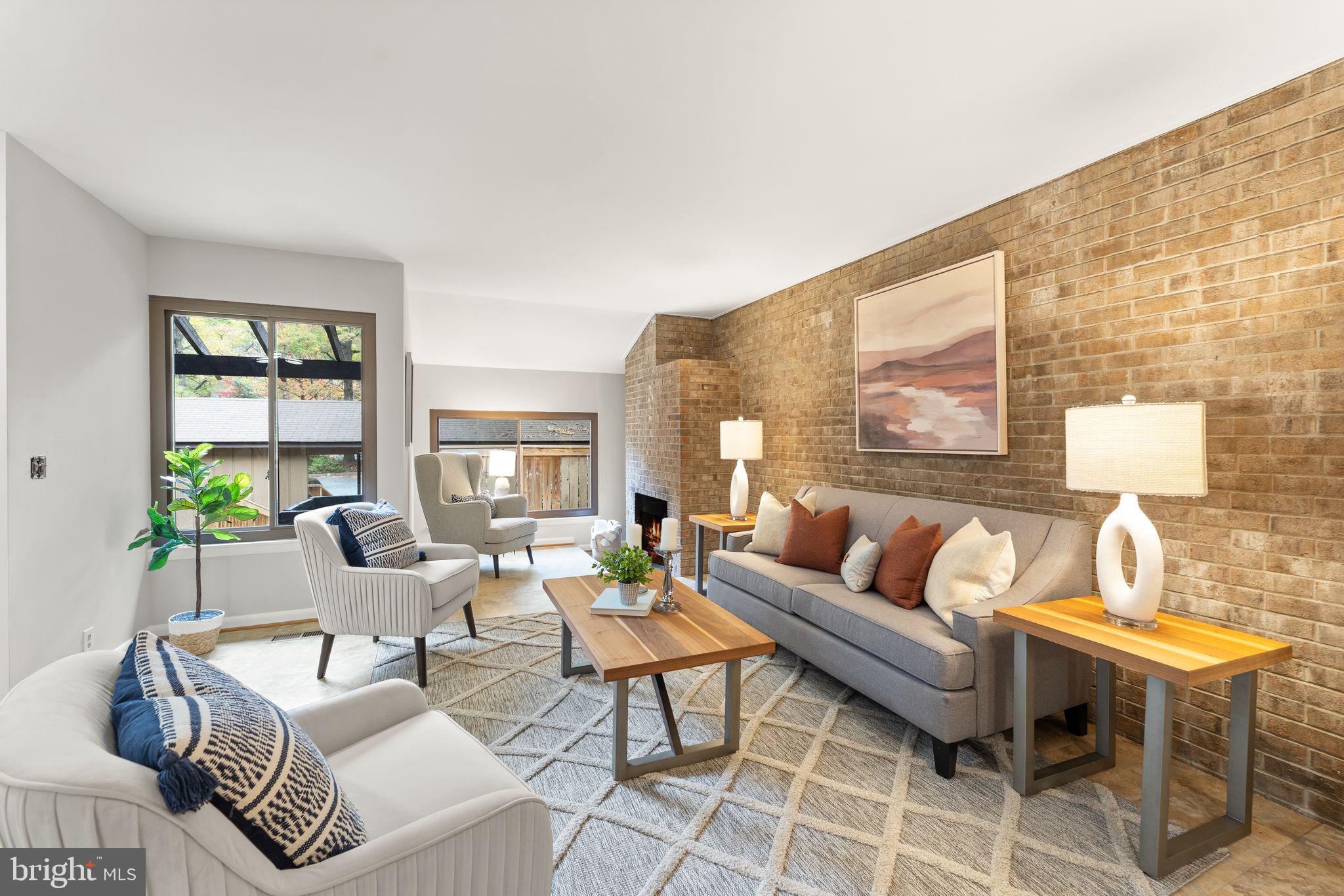 11917 Escalante Court Reston, VA 20191 - Photo 9 of 51 a living room with fireplace furniture and a floor to ceiling window