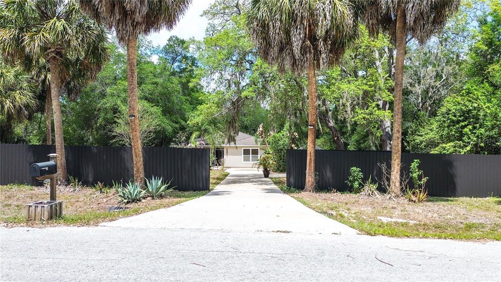 9641 Fulton Avenue Hudson, FL 34667 - Photo 1 of 60 a front view of a house with a yard and tree