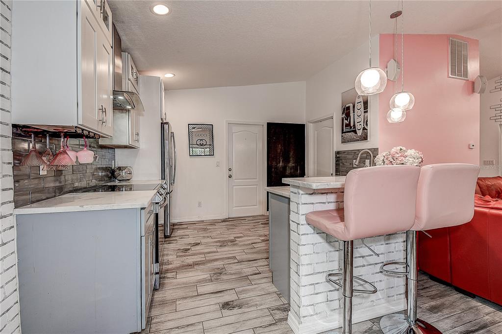 9641 Fulton Avenue Hudson, FL 34667 - Photo 11 of 60 a kitchen with a table and chairs in it