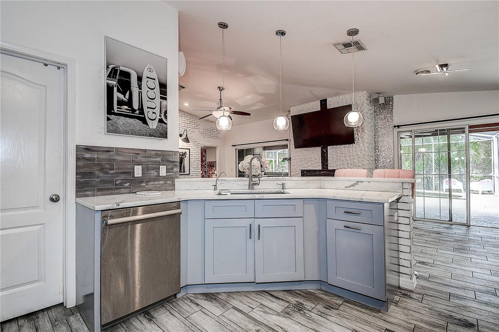 9641 Fulton Avenue Hudson, FL 34667 - Photo 12 of 60 a kitchen with a sink and cabinets