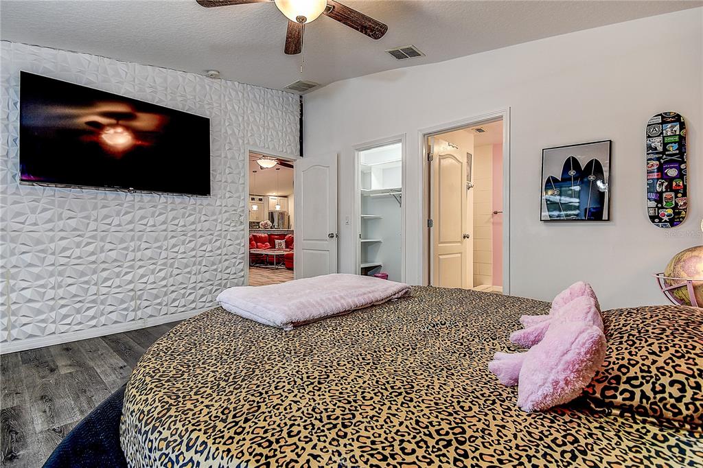 9641 Fulton Avenue Hudson, FL 34667 - Photo 19 of 60 a bedroom with a bed and a flat screen tv