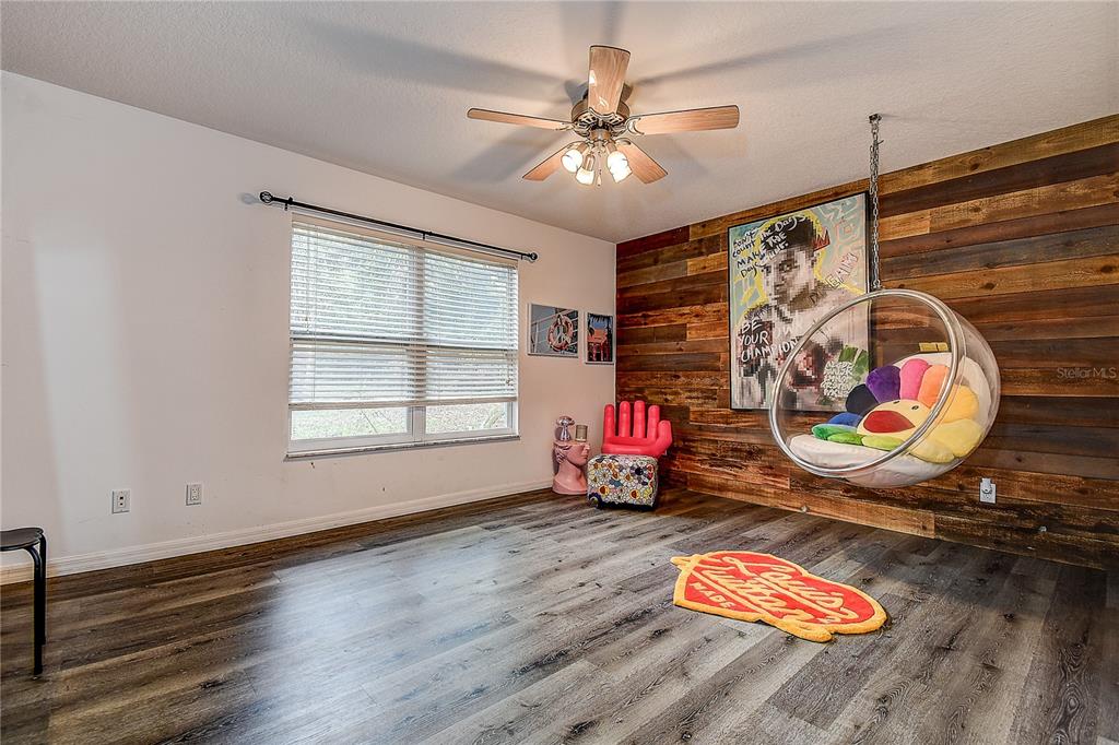 9641 Fulton Avenue Hudson, FL 34667 - Photo 22 of 60 a view of a room with wooden floor and chandelier