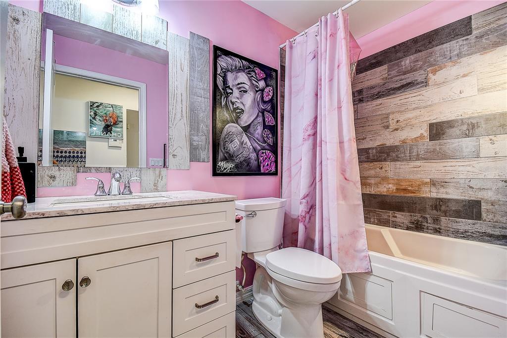 9641 Fulton Avenue Hudson, FL 34667 - Photo 24 of 60 a bathroom with a granite countertop toilet sink and mirror