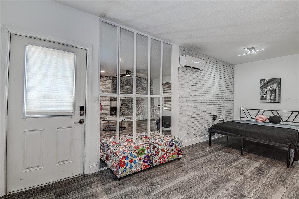 9641 Fulton Avenue Hudson, FL 34667 - Photo 28 of 60 a bedroom with bed and wooden floor