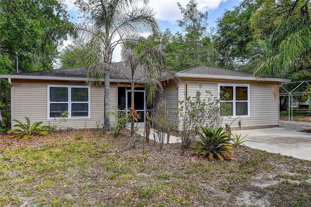 9641 Fulton Avenue Hudson, FL 34667 - Photo 3 of 60 a house that has a tree in front of it