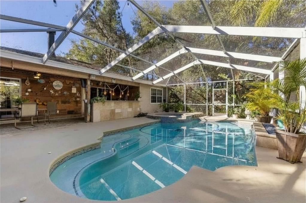9641 Fulton Avenue Hudson, FL 34667 - Photo 35 of 60 a view of a swimming pool with a patio