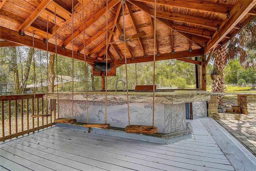 9641 Fulton Avenue Hudson, FL 34667 - Photo 43 of 60 a view of outdoor space with wooden floor and barbeque
