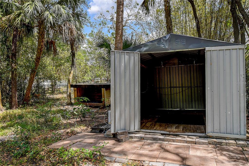 9641 Fulton Avenue Hudson, FL 34667 - Photo 54 of 60 a front view of a house with garden