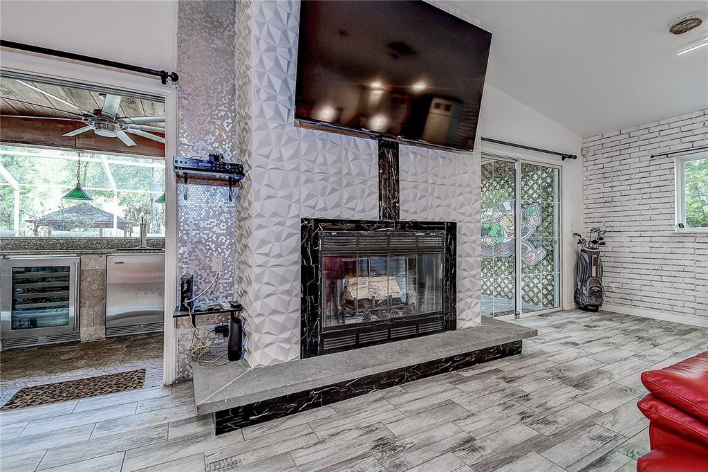9641 Fulton Avenue Hudson, FL 34667 - Photo 8 of 60 a living room with furniture and a fireplace