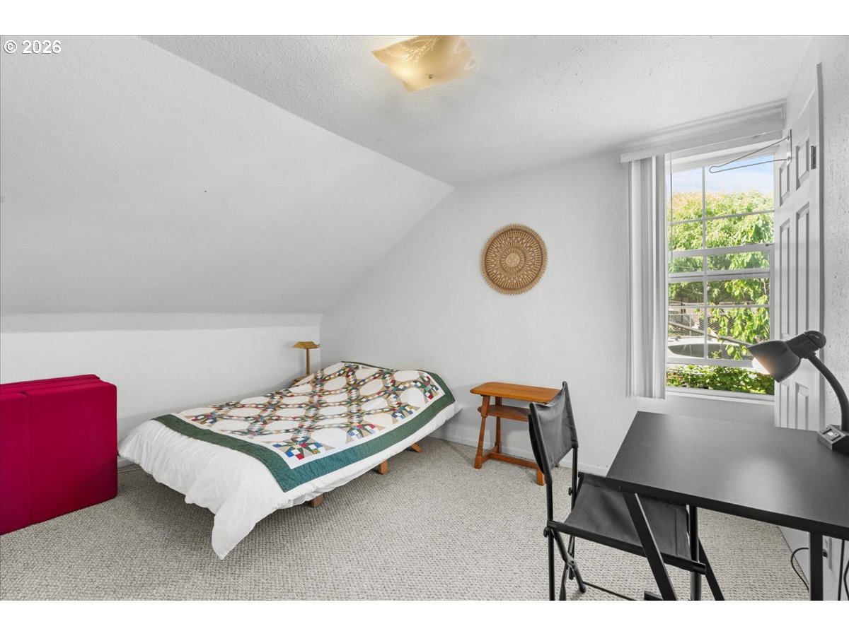 772 Division Street Oregon City, OR 97045 - Photo 18 of 47 a bed room with a bed chair and a window