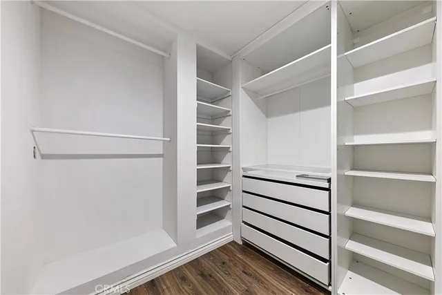 a view of walk in closet with empty racks