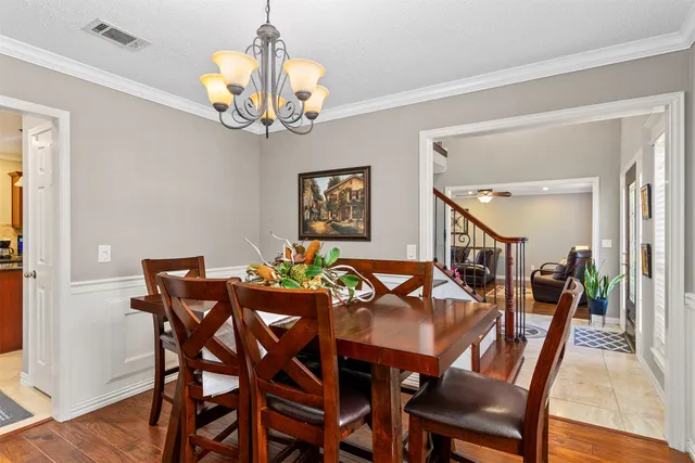 a view of a dining room with furniture and chandelier