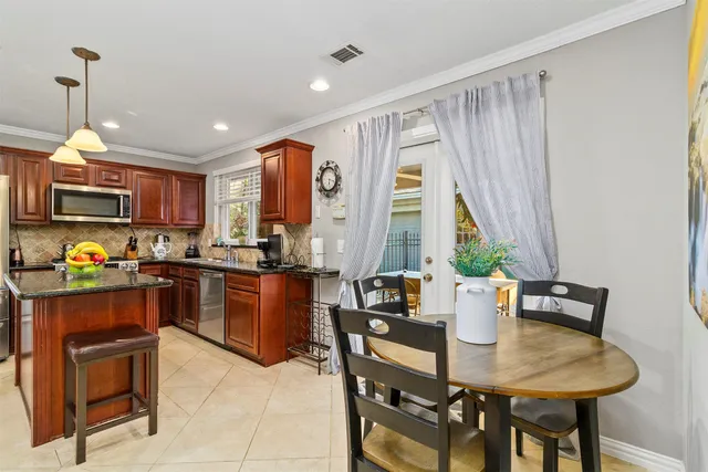 a kitchen with a table chairs and microwave
