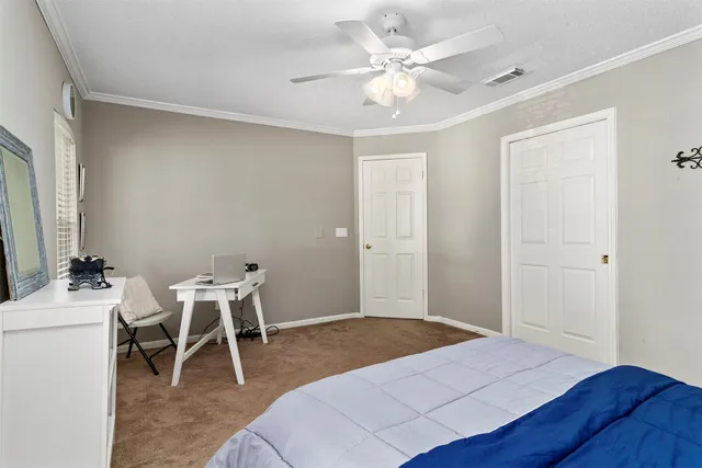 a bedroom with a bed and a table in it