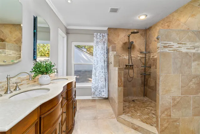 a bathroom with a granite countertop sink a shower and a mirror
