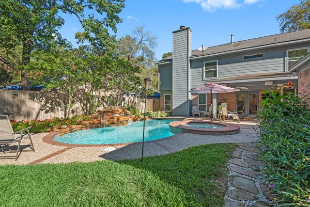 a view of a house with backyard and sitting area