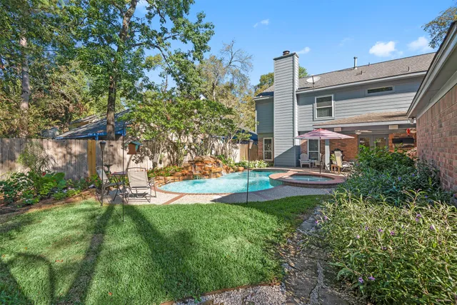 a view of a house with a yard and sitting area