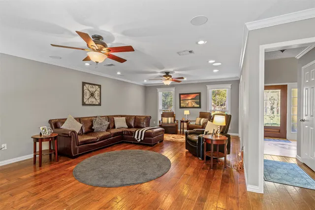 a living room with furniture and wooden floor
