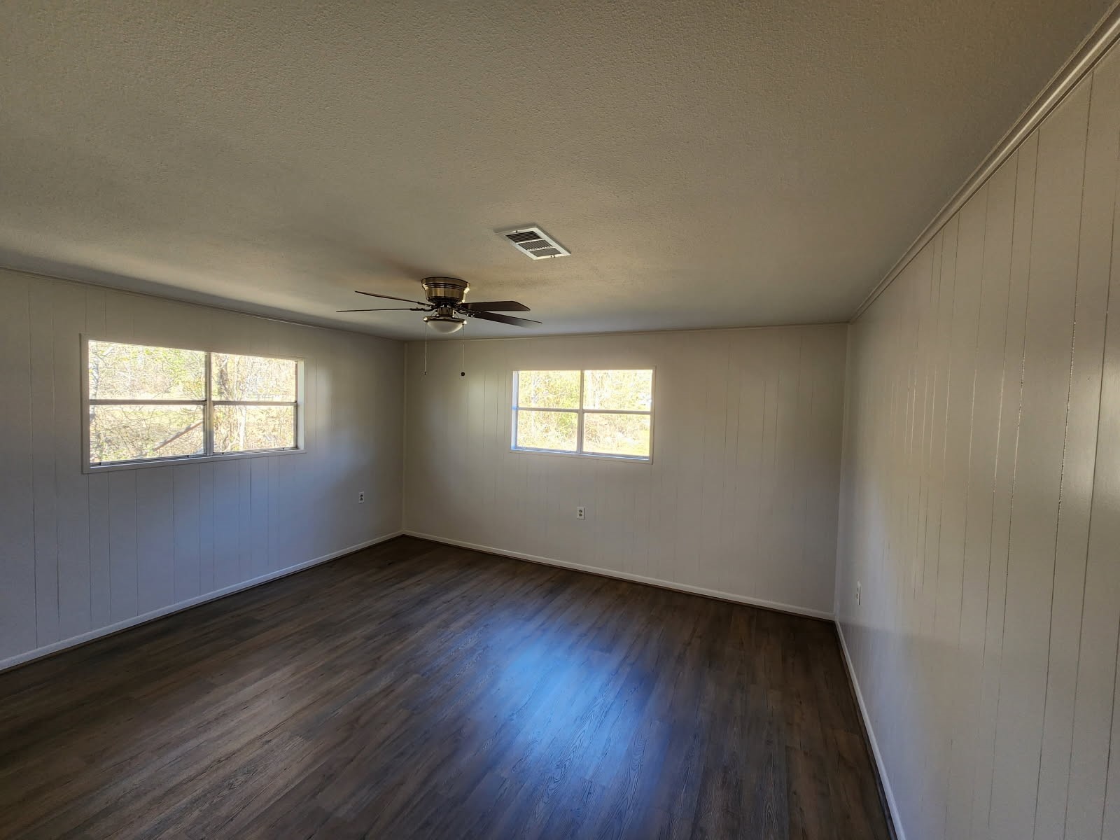 983 Triple Creek Loop Livingston, TX 77351 - Photo 15 of 26 an empty room with wooden floor and windows