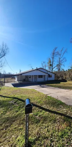 a kitchen with granite countertop wooden floors stainless steel appliances and sink