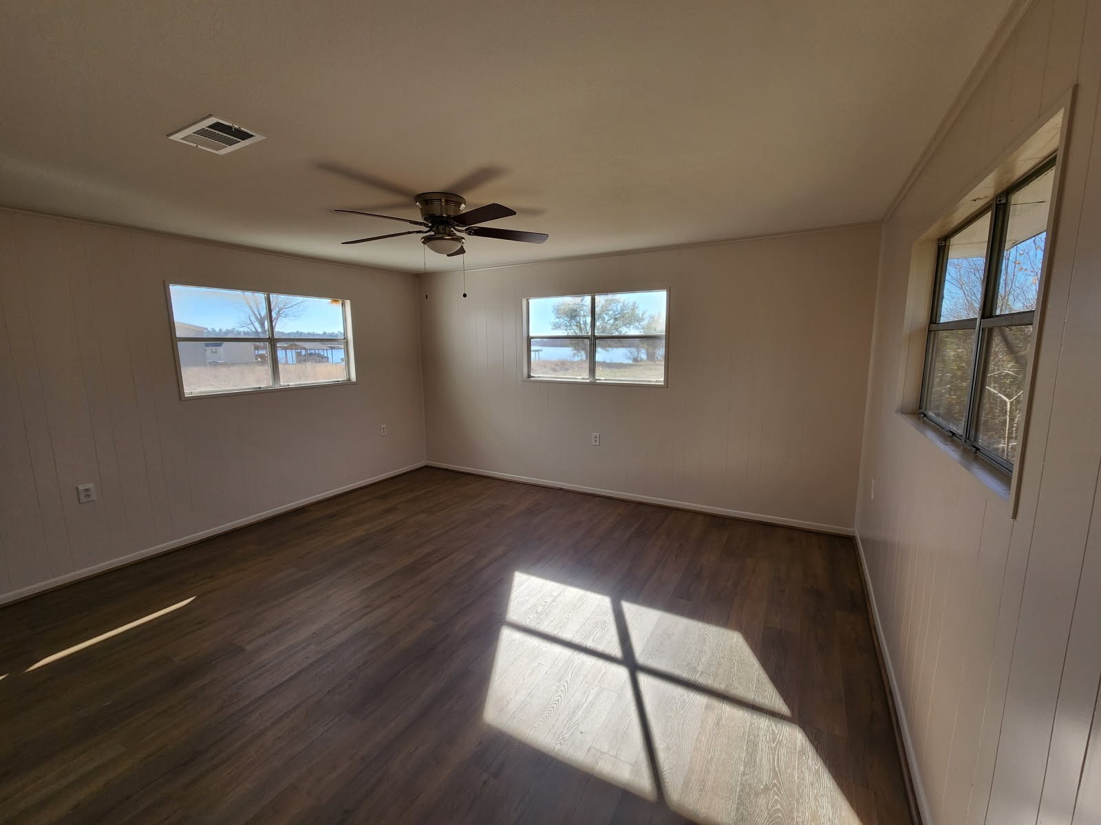 983 Triple Creek Loop Livingston, TX 77351 - Photo 10 of 26 a view of an empty room with a window and wooden floor