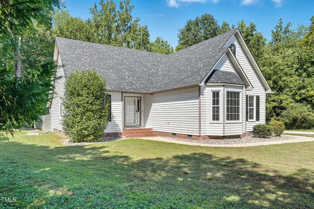 a front view of a house with a garden
