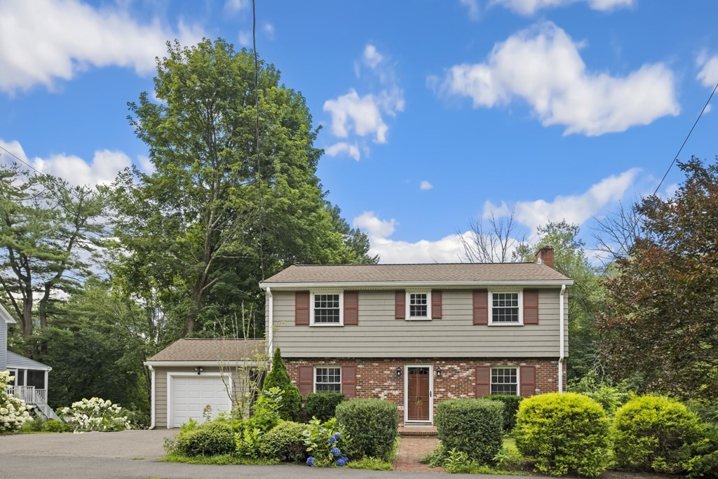58 Oak Street Reading, MA 01867 - Photo 4 of 40 a front view of a house with a yard