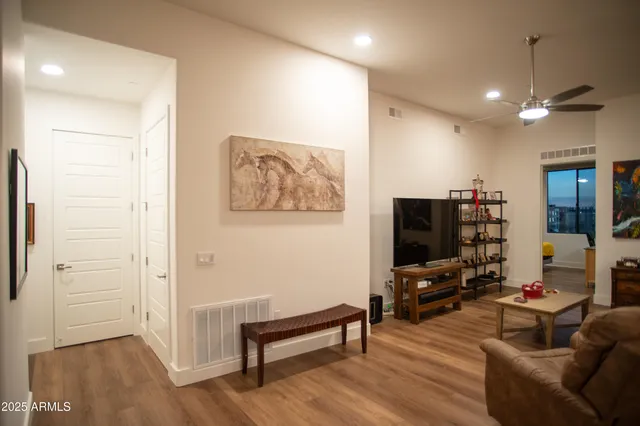 a living room with furniture and a dining table with kitchen view