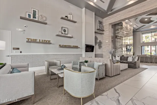 a living room with furniture and large windows