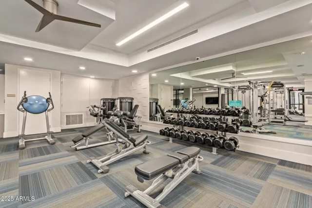 a view of a dining room with furniture a chandelier and wooden floor