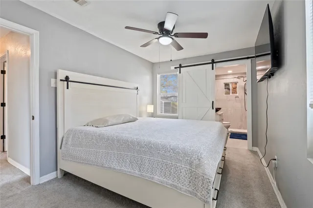 a bedroom with a bed and a ceiling fan
