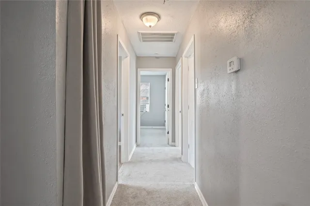 a view of a hallway view with wooden floor