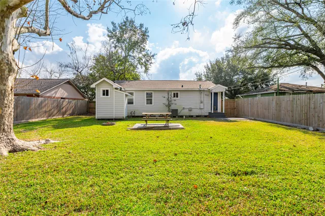 a house view with swimming pool in front of it