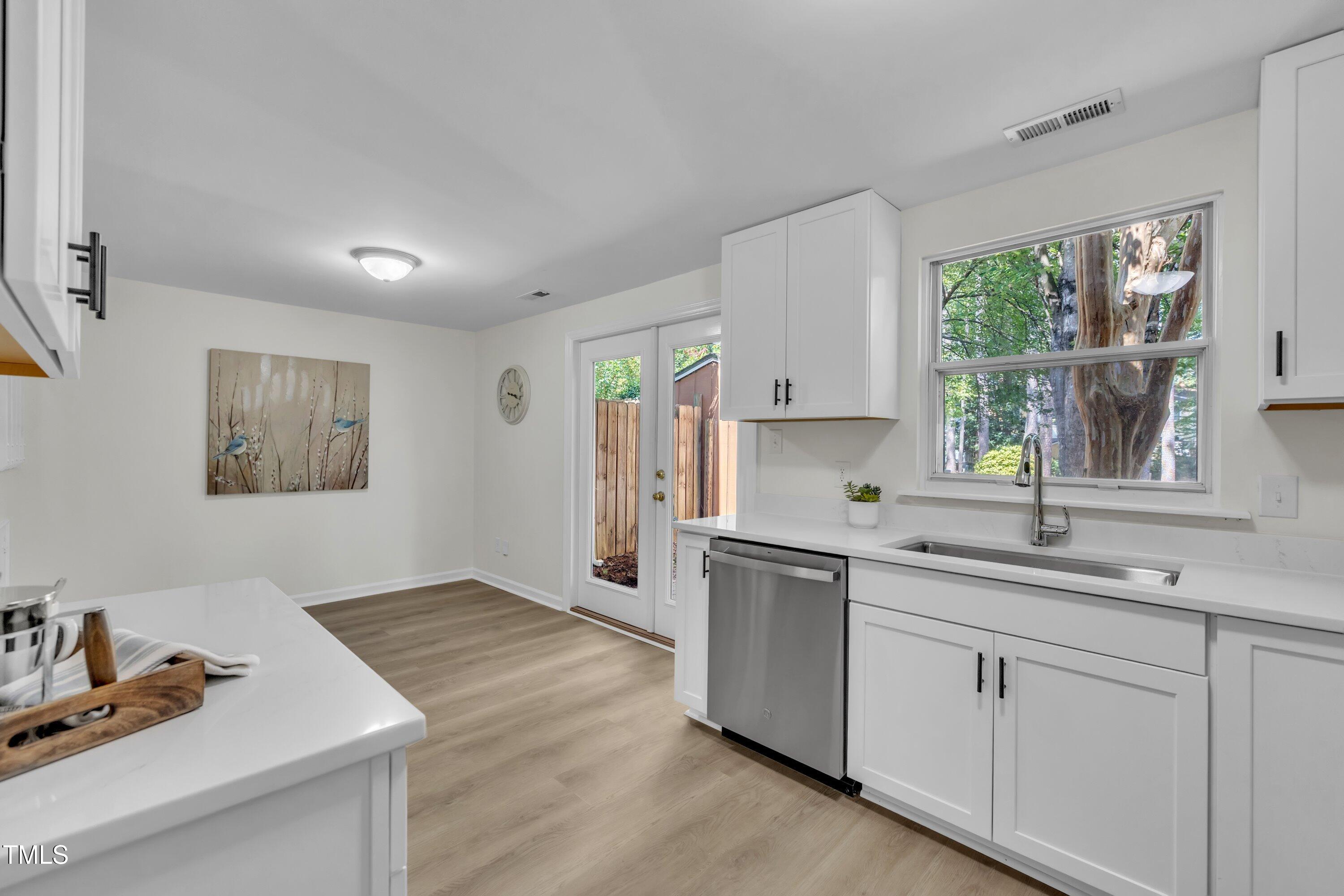 632 Middleton Avenue Cary, NC 27513 - Photo 18 of 34 a kitchen with a sink cabinets and window
