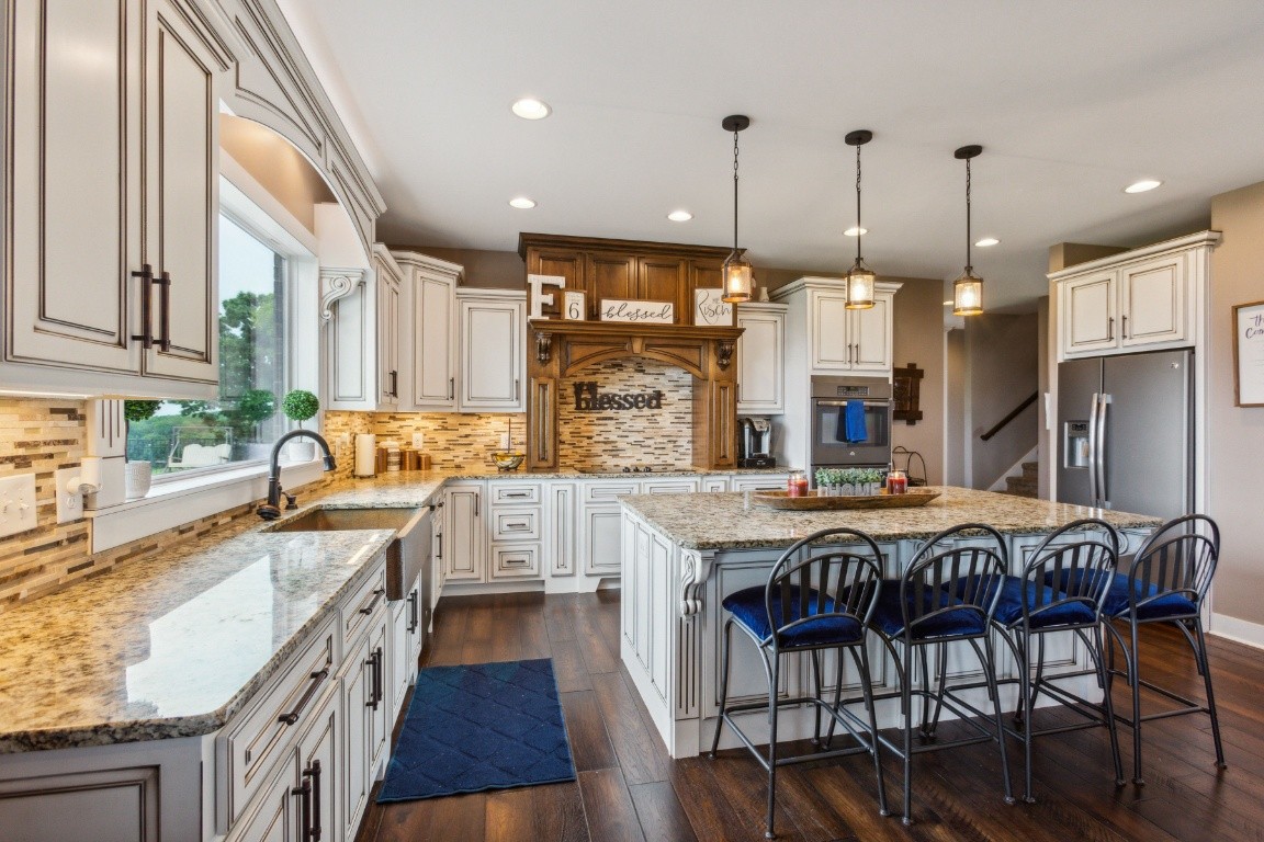 215 George Akins Road Westmoreland, TN 37186 - Photo 14 of 39 a large kitchen with a table chairs and a wooden floor