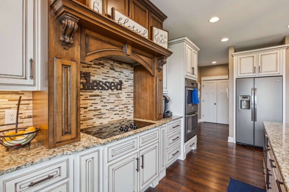 215 George Akins Road Westmoreland, TN 37186 - Photo 17 of 39 a kitchen with stainless steel appliances granite countertop a refrigerator and wooden cabinets
