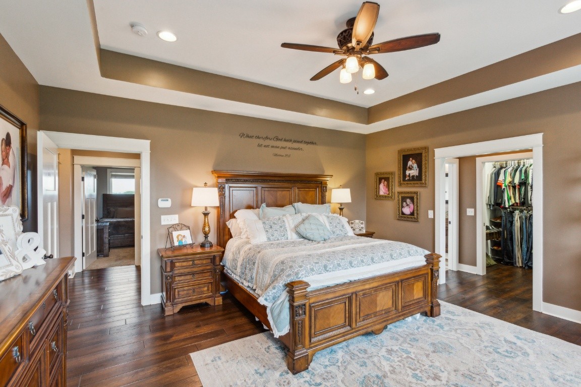 215 George Akins Road Westmoreland, TN 37186 - Photo 21 of 39 a bedroom with a large bed a chandelier and closet