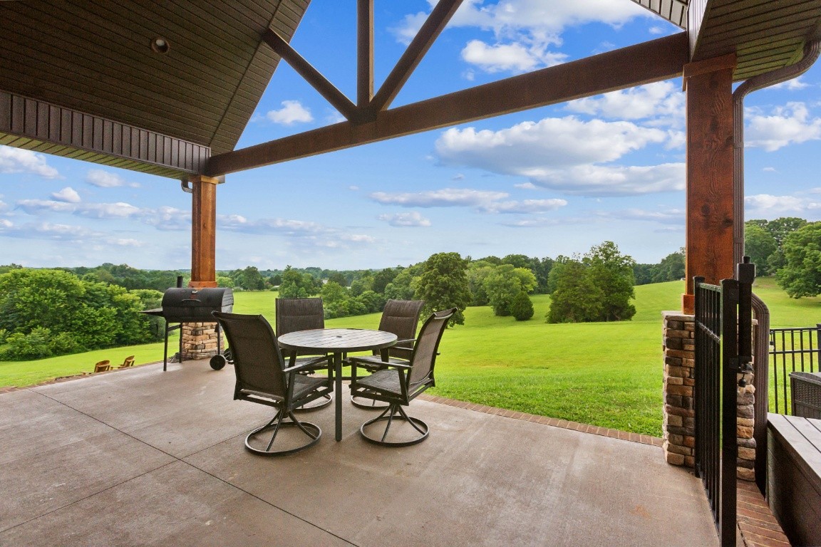 215 George Akins Road Westmoreland, TN 37186 - Photo 36 of 39 a view of a patio with a table chairs and a yard