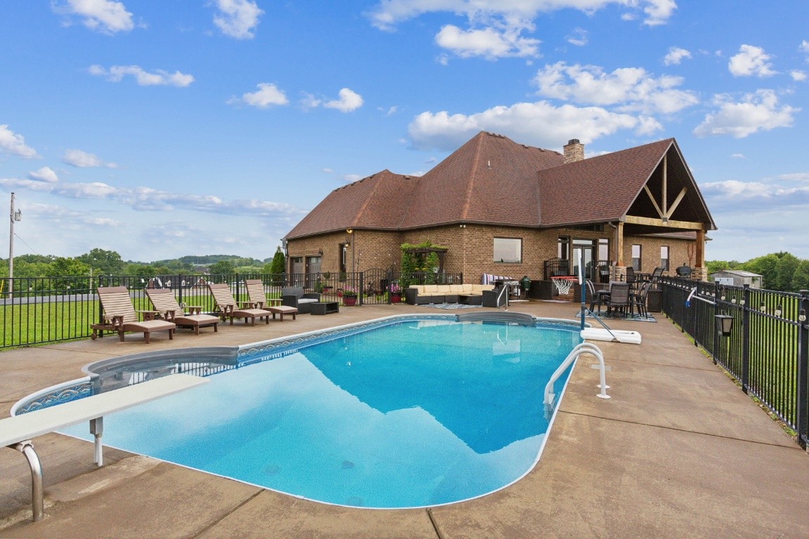 215 George Akins Road Westmoreland, TN 37186 - Photo 37 of 39 a view of a house with swimming pool and sitting area