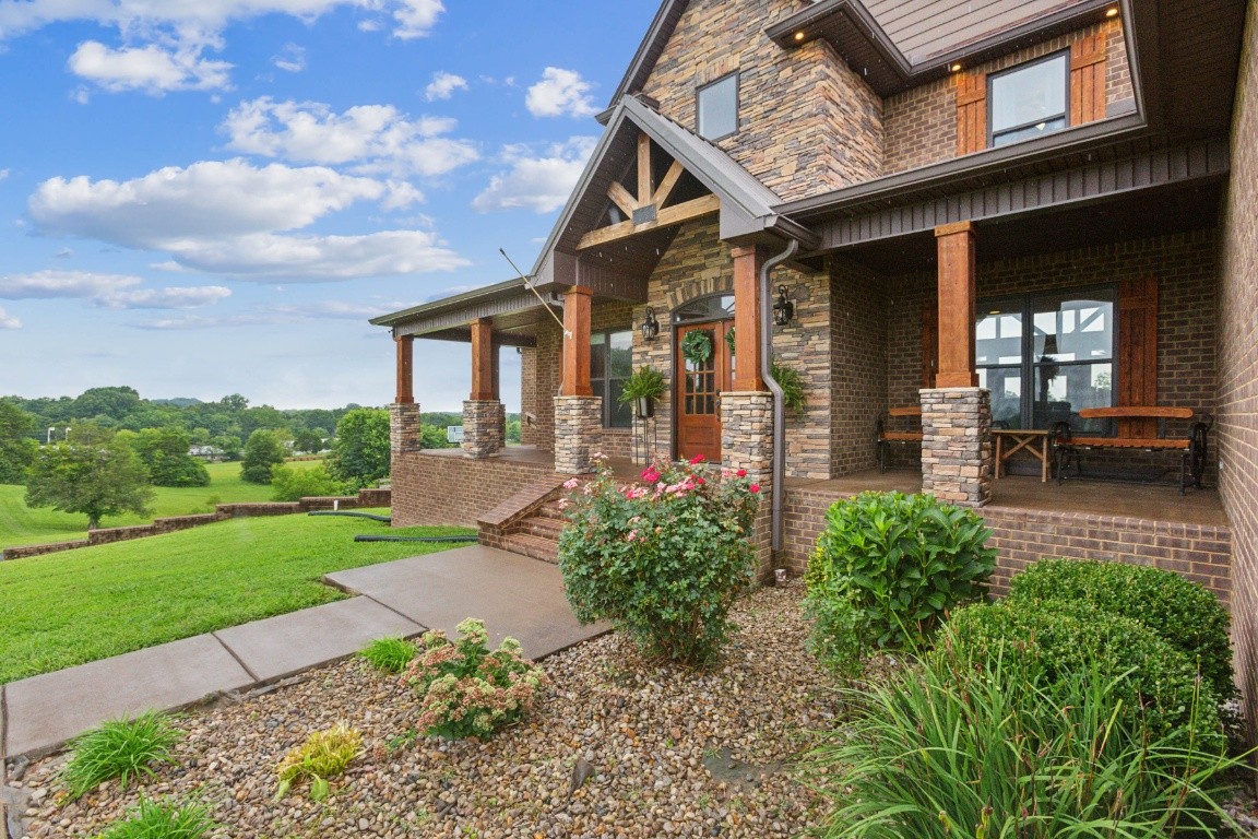 215 George Akins Road Westmoreland, TN 37186 - Photo 6 of 39 a front view of a house with garden
